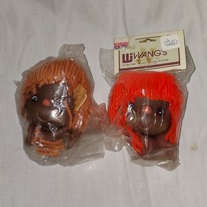 2 doll heads with hands